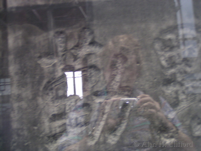 Reflection in the case protecting a stele