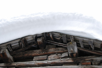 Snow on the roof of a wooden building