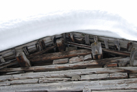 Snow on the roof of a wooden building